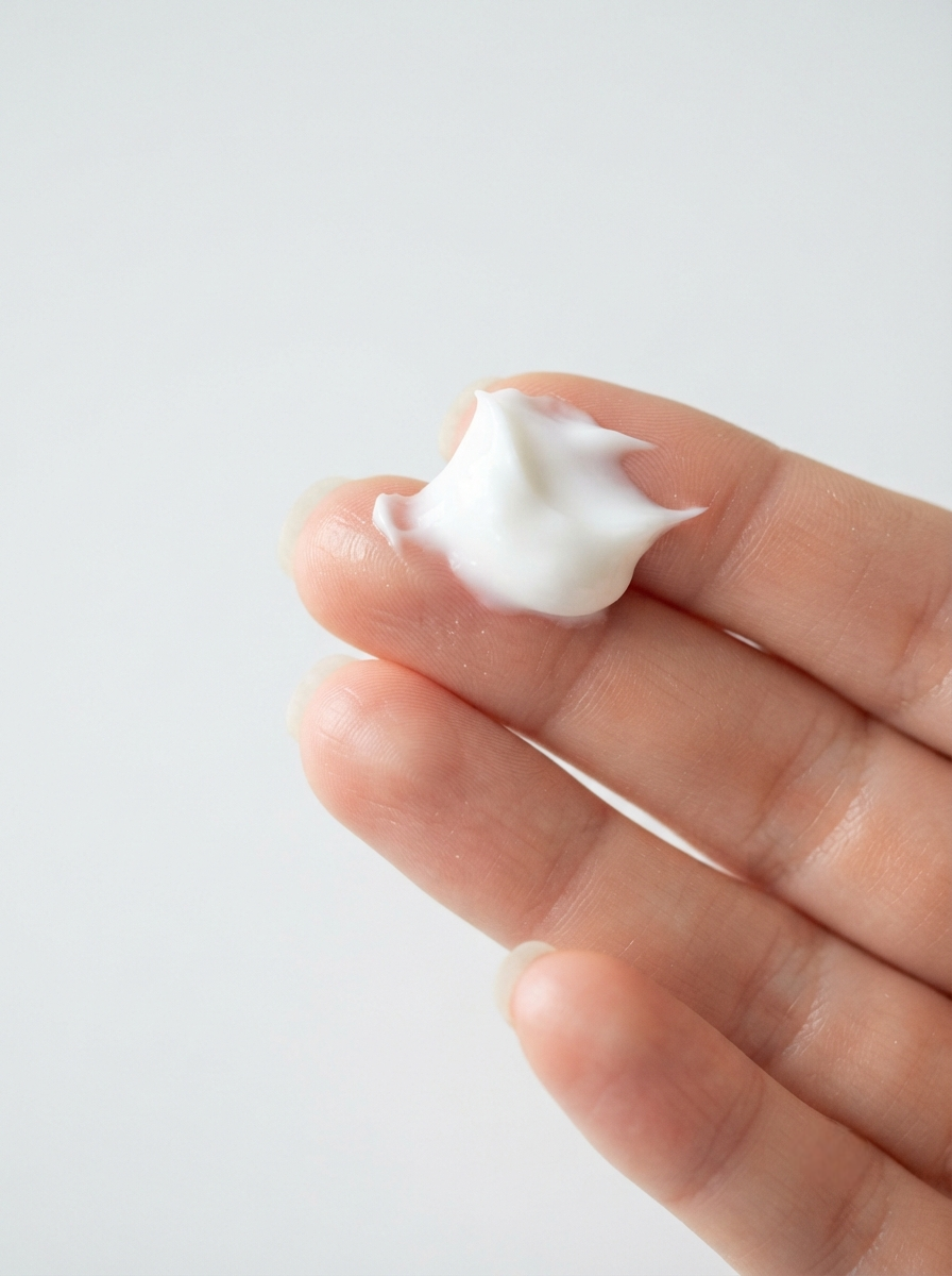 Shake the bottle thoroughly and dispense a generous, coin-sized amount of the fluid sunscreen onto your fingertips